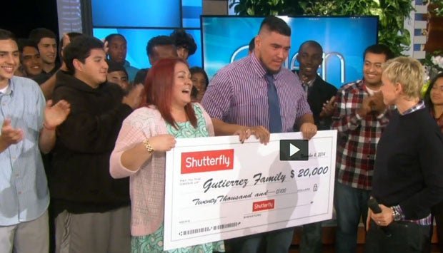 Hawthorne assistant football coach Sione Gutierrez and wife Vanessa Williams receive a check for $20,000 from Shutterfly on Monday's taping of the "Ellen" show. Hawthorne team members cheer on.