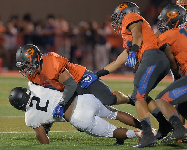 Bishop Gorman defensive tackle Blake Forte tackles Cocoa running back Timmy Pratt in the backfield.