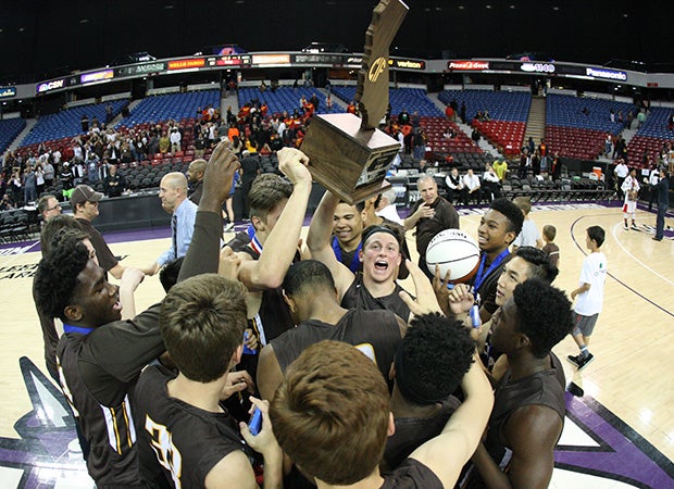 Crespi players hoist the championship trophy following their victory in the CIF State Division I title game Thursday night in Sacramento.