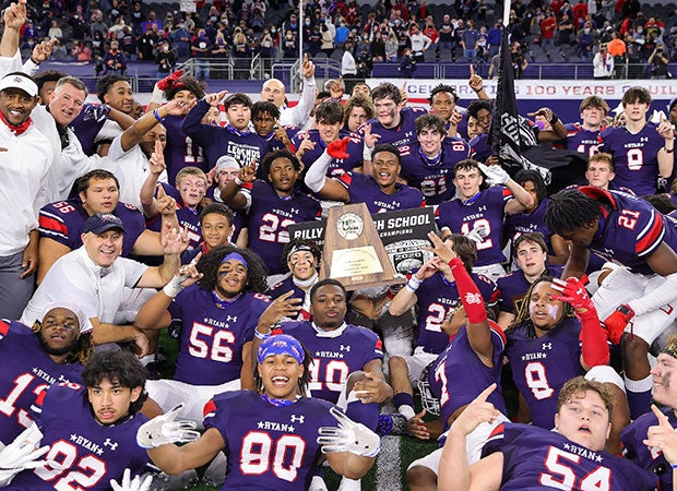 Ryan coaches and players celebrate while displaying the state championship trophy.