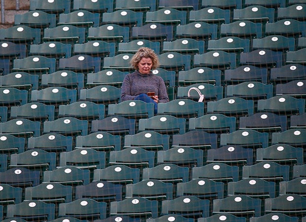 A fan practices social distancing while attending the Del Oro vs. Vista Del Lago junior varsity baseball game at Sutter Heath Park in West Sacramento on March 7. Five days later, high school sports in California and other states was halted due to the coronavirus pandemic.