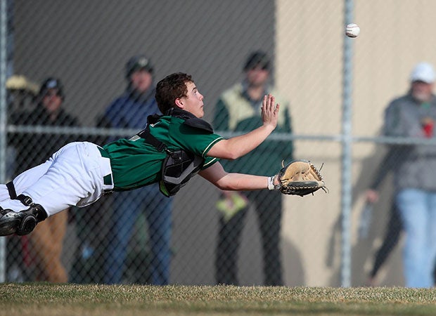 Catcher Blake Young of Mountain Vista (Colo.) lays out in an attempt to catch a pop up against Dakota Ridge.