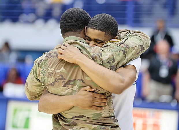 Isaiah Bridges of Westover (N.C.) is surprised by his brother's return from serving in Afghanistan minutes before the tip-off of the NCHSAA Regional 3A basketball championship game.