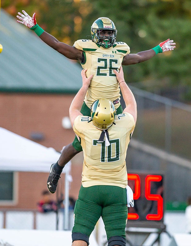 Phil Mafah of Grayson (Ga.) is held aloft by offensive lineman Griffin Scroggs while celebrating a touchdown against Parkview.