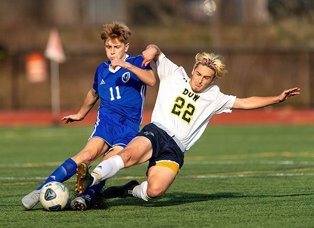 Oyster River's (N.H.) Ethan Wilson (left) fends off a challenge from Ryan Leonard of Bow during the NHIAA Division 2 state championship.