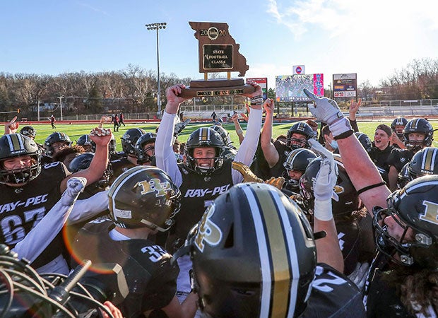 Raymore-Peculiar (Mo.) quarterback Conrad Hawley raises the MSHSAA Class 6 state championship trophy surrounded by his teammates after their 23-0 victory over De Smet Jesuit.