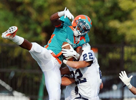 Ayo Ogunniyi of Westlake leaps high for a pass during Saturday's game.