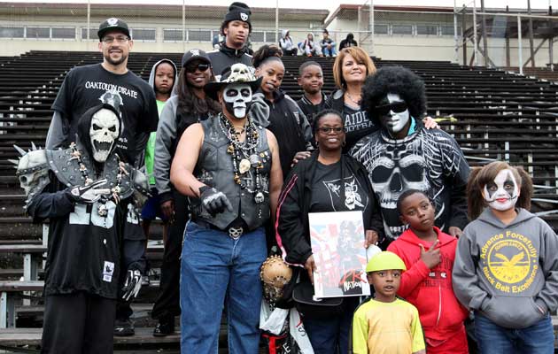 Family members of the late Azel Wendell Gratsy join members of the Oakland Raiders' Black Hole at the Oakland Athletic League game between Fremont and Oakland.