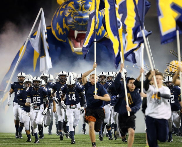 Stony Point (Texas) players run onto the field before the kickoff of their game against Pflugerville.