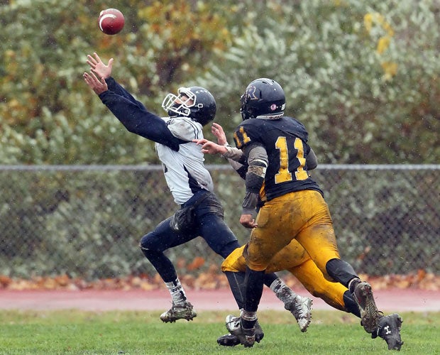 Wethersfield (Conn.) receiver Kyle Klavins reaches while hauling in a catch against RHAM.