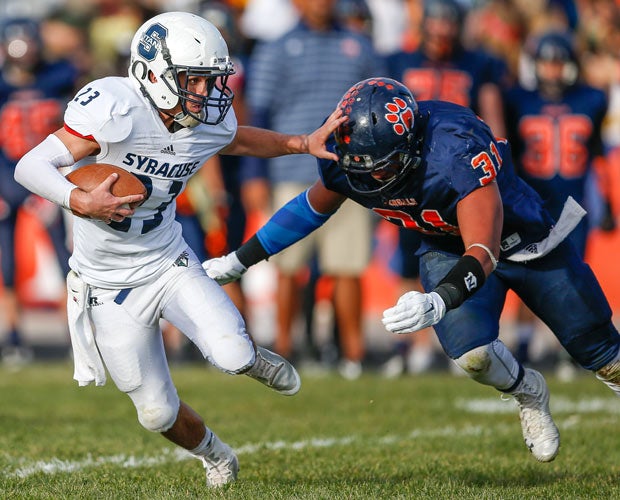 Syracuse (Utah) running back Bridger Naylor attempts to avoid diving Brighton safety Jeremy Fehoko in a UHSAA 5A playoff game.
