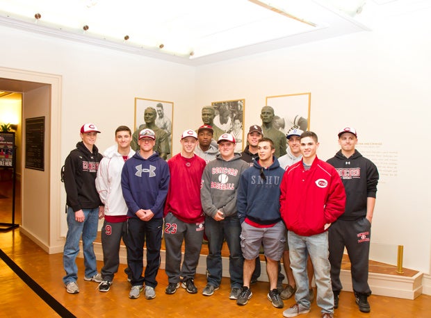 Players from Concord High (N.H.) pose in front of statues of Lou Gehrig, Jackie Robinson and Roberto Clemente.