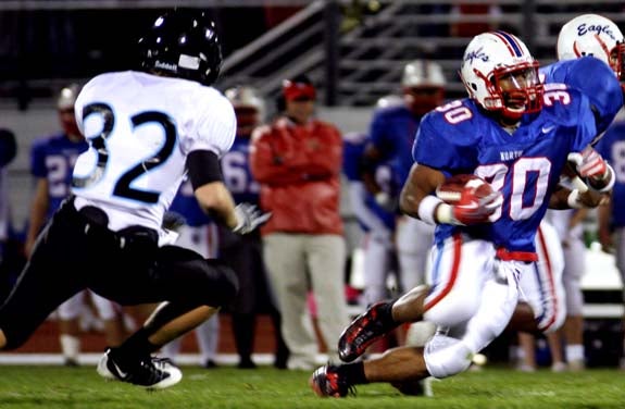 Olathe North running back James Franklin (30) cuts upfield as a Shawnee Mission East defender closes in. Franklin is within striking distance of Darren Sproles' school career rushing record.