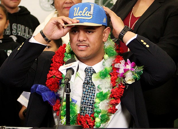 Boss Tagaloa proudly puts on a UCLA hat while announcing his college choice.