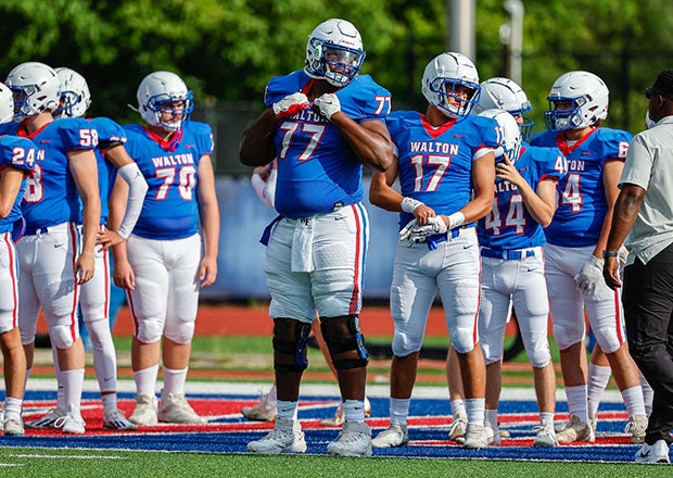 Daniel Calhoun, shown here towering above teammates during a scrimmage earlier this month, was one of the most heavily-recruited offensive linemen in the country prior to committing to the Georgia Bulldogs. (Photo: Cecil Copeland)