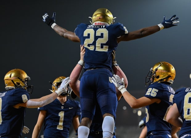 E.J. Smith celebrates a touchdown in the playoffs against Klein Collins.