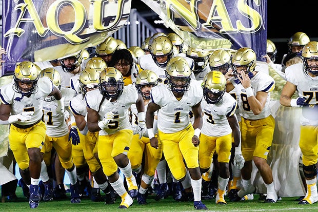 St. Thomas Aquinas takes the field for last year's Class 7A state championship game. The Raiders have played for a title 16 times in 22 seasons during the 2000s.