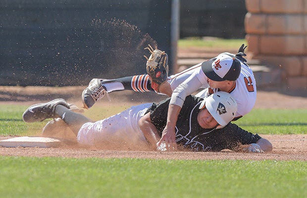 Desert Edge (Goodyear, Ariz.) third baseman Julian Garcia (top) collides with a Neah-Kah-Nie base runner on a steal during a game in the Coach Bob Invitational in Arizona.