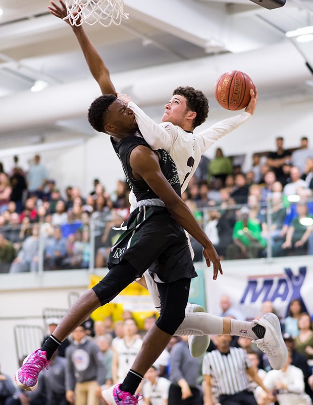 St. Francis (Mountain View, Calif.) guard Logan Johnson collides with a Moreau Catholic player while attempting a dunk in the CIF NorCal Regional Division 2 title game.