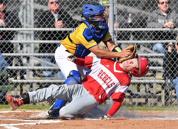 Casey Payne of Sam Rayburn (Ivanhoe, Texas) is tagged out at home plate by a Bland catcher during a game in the Blue Ridge Tournament in Texas.