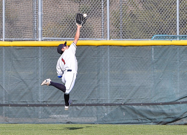 Steele Canyon (Spring Valley, Calif.) center fielder Matthew Brinkmeier makes a leaping over-the-shoulder catch against Patrick Henry.