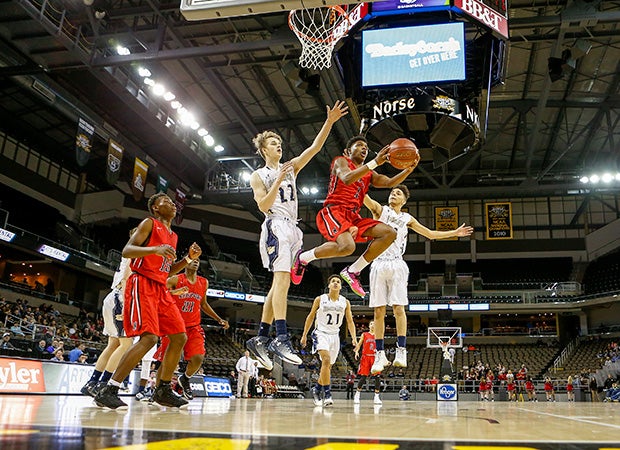 Newport (Ky.) point guard Rico Hollis soars to the basket between two Sterling Hamilton defenders during a game in the KHSAA Ninth Region Tournament.