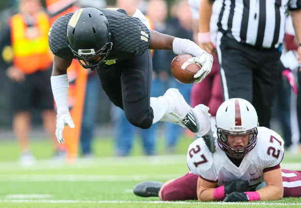 Paramus Catholic (N.J.) ball carrier Ahmad Thomas leaps for extra yardage against Don Bosco Prep (Ramsey, N.J.).