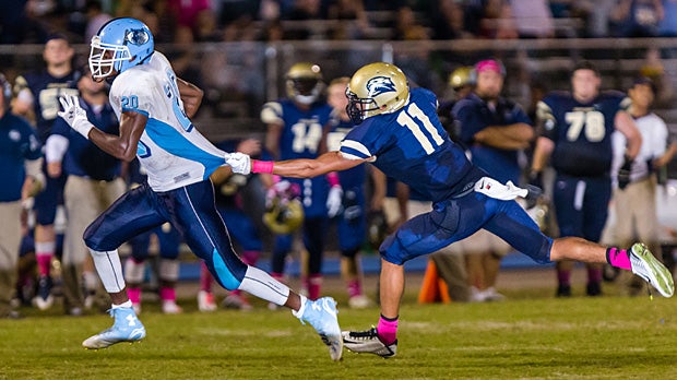 Runner Donovan Geter of Newsome (Lithia, Fla.) attempts to pull away from Tracy Watson Jr. of Durant (Plant City, Fla.).