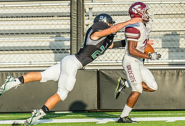 A Clear Falls (League City, Texas) defender attempts to bring down a Clear Creek (League City, Texas) ball carrier from behind.