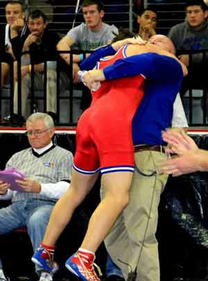Coach Bob Callison shares a hug with statechampion Ryan Gallo.