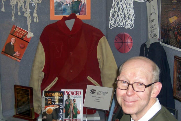MaxPreps' Krider poses in front of his display at the Hall of Fame.