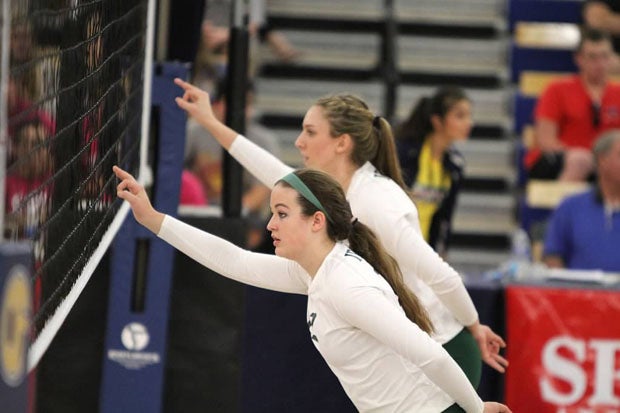 Jen Ryan and Madison Murtagh (background) at the net before serve.