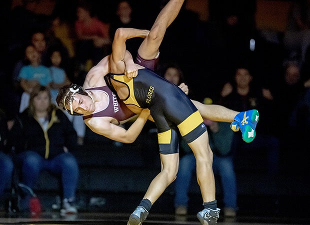 A Whitney (Calif.) wrestler prepares to takedown a Del Oro wrestler.