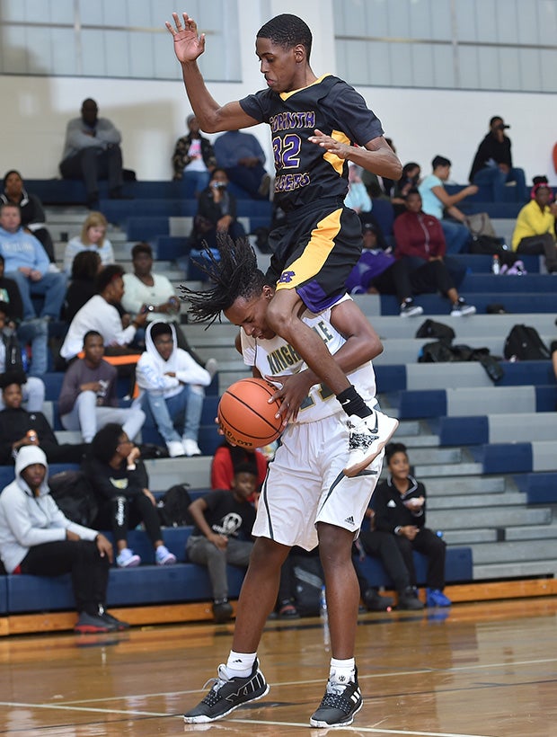 Guard Rodney Ellis of Knighdale (N.C.) is fouled from behind by Jermaine Best of Corinth Holders after faking a shot attempt.