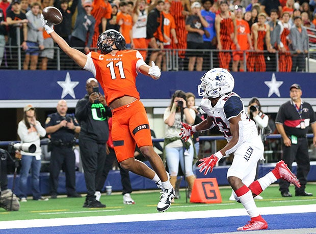 Rockwall (Texas) receiver Jaxon Smith-Njigba make a one-handed touchdown grab in front of an Allen defender during a UIL 6A Division 1 Region II playoff game at AT&T Stadium.