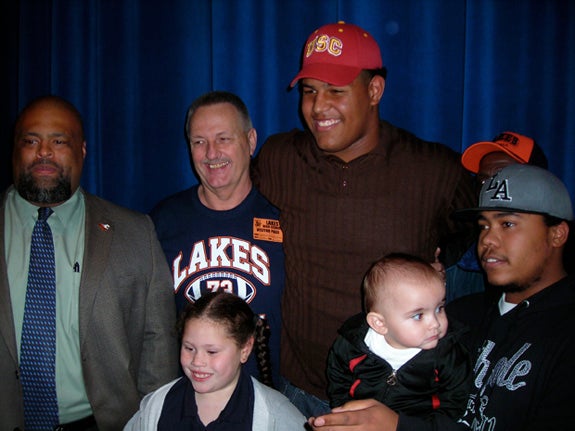 Zach Banner poses with family and friends at Monday's signing day ceremony on campus.