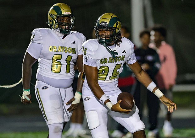Aiden Williams (61) and Olafemi Hunter (86) celebrate a touchdown in the third quarter that helped blow Friday's matchup with Collins Hil wide open. (PHOTO: Brandon Sumrall)
