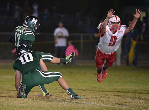 A Ripon (Calif.) player leaps to try and block a kick against Hilmar (Calif.).