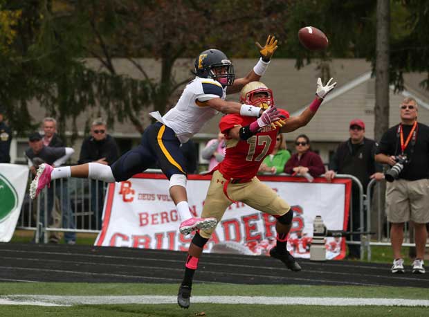 Jalen Tabor of Friendship Collegiate Academy (Washington, D.C.) skies to get the ball away from Bergen Catholic (N.J.) player Michael Martinez.