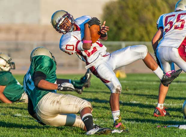 A ballcarrier from Northgate (Walnut Creek, Calif.) gets tricky to avoid tacklers from Concord (Calif.).