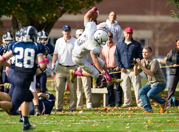A Lawrence Academy (Groton, Mass.) ballcarrier gets airborne against Noble & Greenough (Dedham, Mass.).