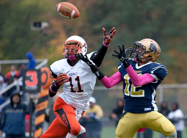 Irving Peay of McKinley (Buffalo, N.Y.) leaps to poke the ball away as a Sweet Home (Amherst, N.Y.) player waits to receive the ball.