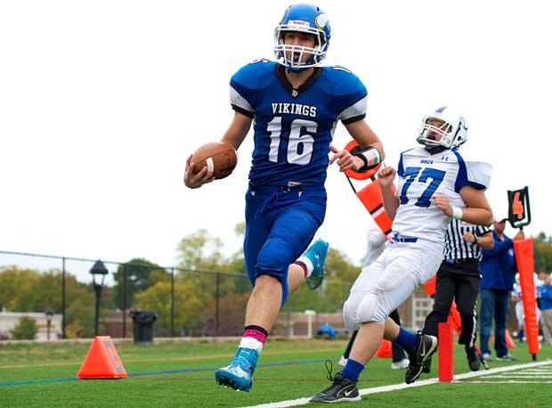 A Port Washington (N.Y.) player scores a touchdown as a Roslyn (Roslyn Heights, N.Y.) player slows down.