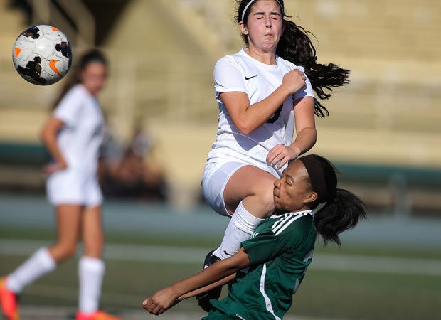 A Granada Hills player (top) collides with a Hamilton (Los Angeles) player while battling for the ball during a game in the Los Angeles Invitational.