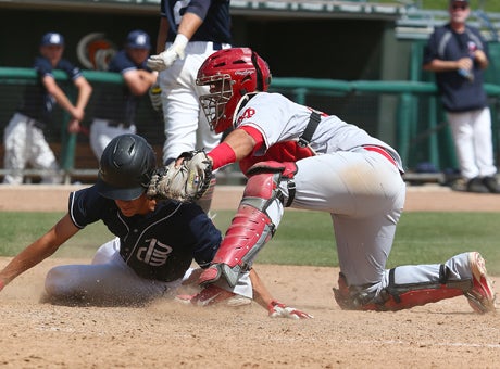 Mater Dei highly-touted catcher Jeremy Martinez tags out Pleasant Grove senior third baseman Austin Friello, setting the tone for a long, scoreless day for the Eagles who dropped an 8-0 Boras Classic final at UOP Saturday. 