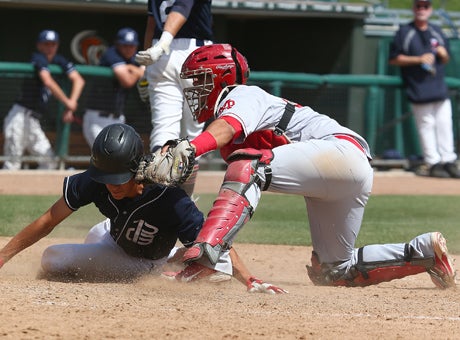 Mater Dei highly-touted catcher Jeremy Martinez tags out Pleasant Grove senior third baseman Austin Friello, setting the tone for a long, scoreless day for the Eagles who dropped an 8-0 Boras Classic final at UOP Saturday.