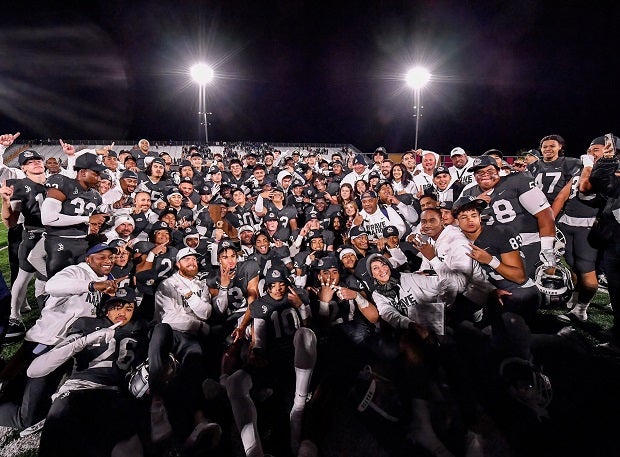 The St. John Bosco football team gathers for a team photo with the CIF Open Division trophy following their 45-0 win over Serra on Saturday at Saddleback College. (Photo: Louis Lopez)