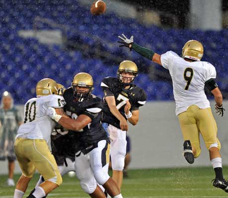 Good Counsel QB Brendan Marshall throws a pass over a leaping defender.