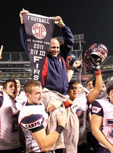 Campolindo coach Kevin Macy is
hoisted by his team after
Saturday's championship win
over Marin Catholic.
