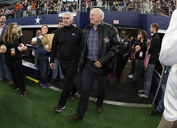 Jerry Jones enters the field at the end of Saturday's title game along with UIL Executive Director Dr. Charles Breithaupt.